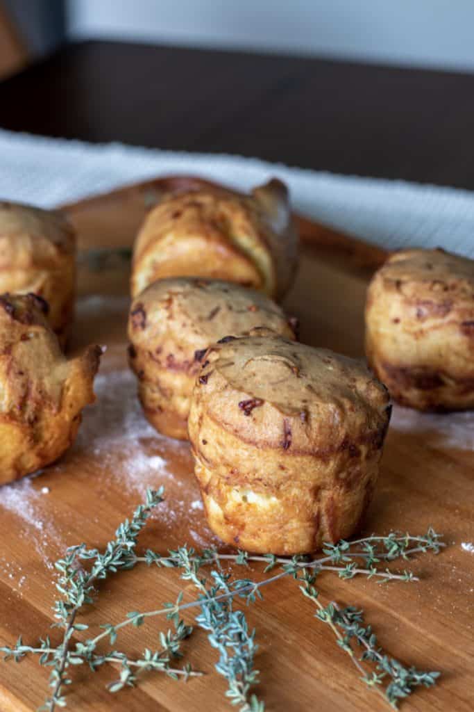 Crispy roasted garlic potatoes on wooden cutting board with thyme sprigs and salt, deliciously baked potato dish, Perfect for comfort food, baked garlic potatoes, easy potato recipes, flavorful side dishes, healthy roasted potatoes.