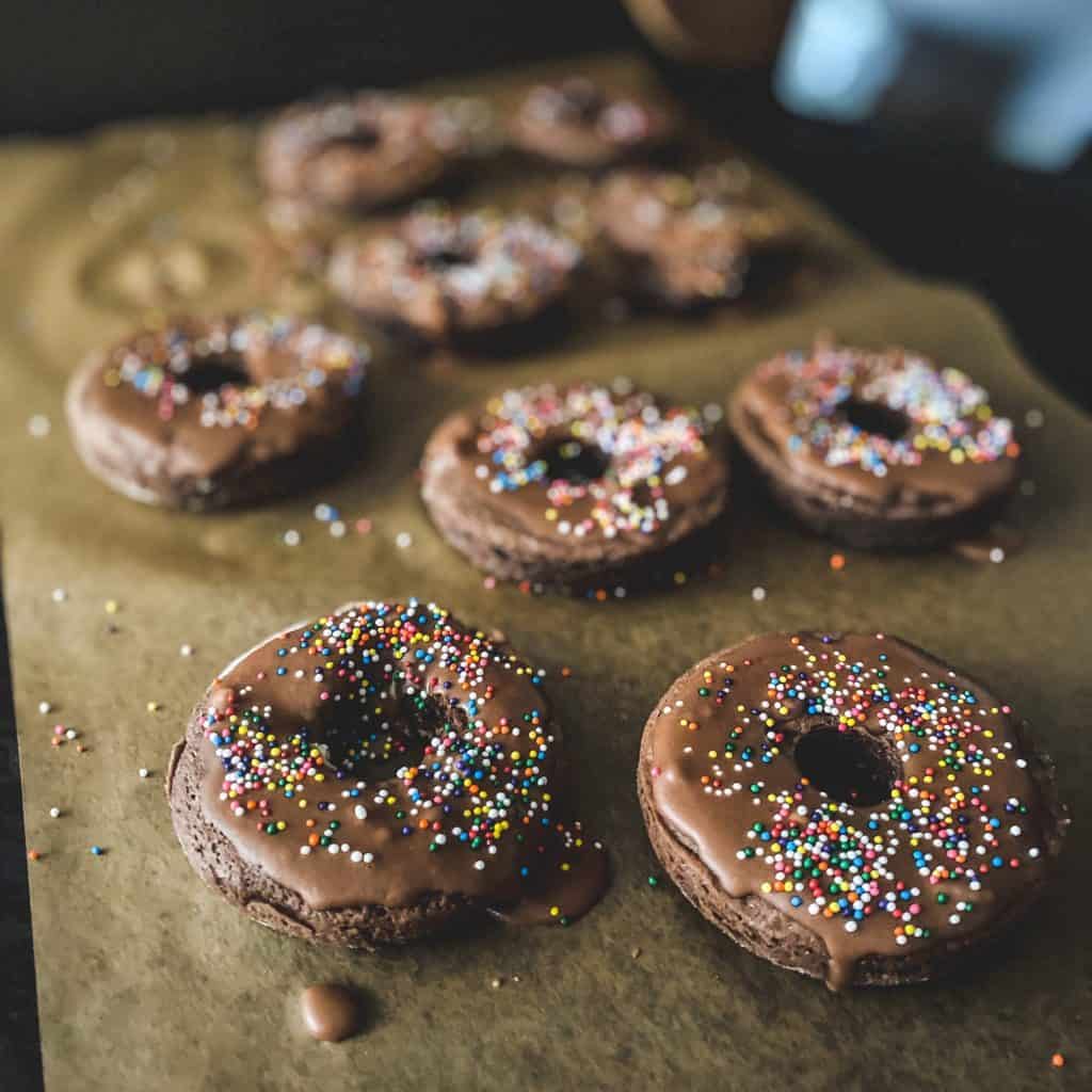 Chocolate Donuts cooling on parchment paper