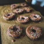Chocolate Donuts cooling on parchment paper