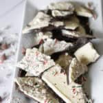Chocolate peppermint bark with white and dark chocolate, topped with crushed peppermint candies, perfect for holiday desserts and festive treats.