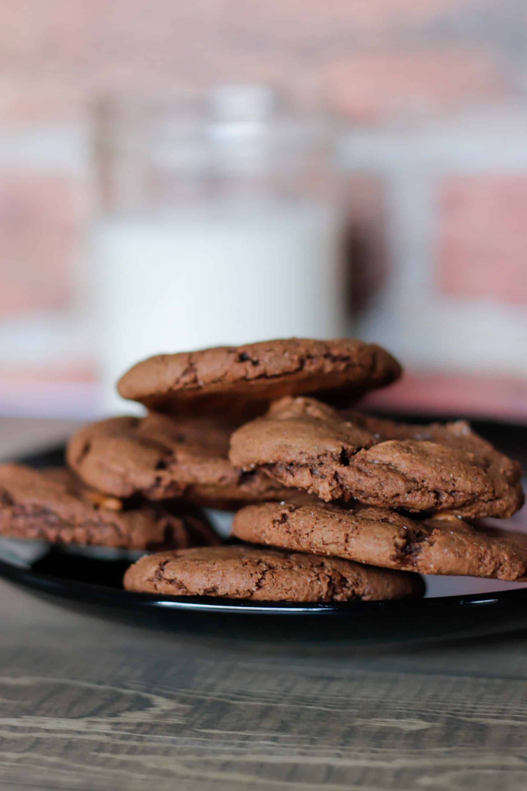 Decadent chocolate chip cookies on a black plate, perfect for homemade treats and snack time.