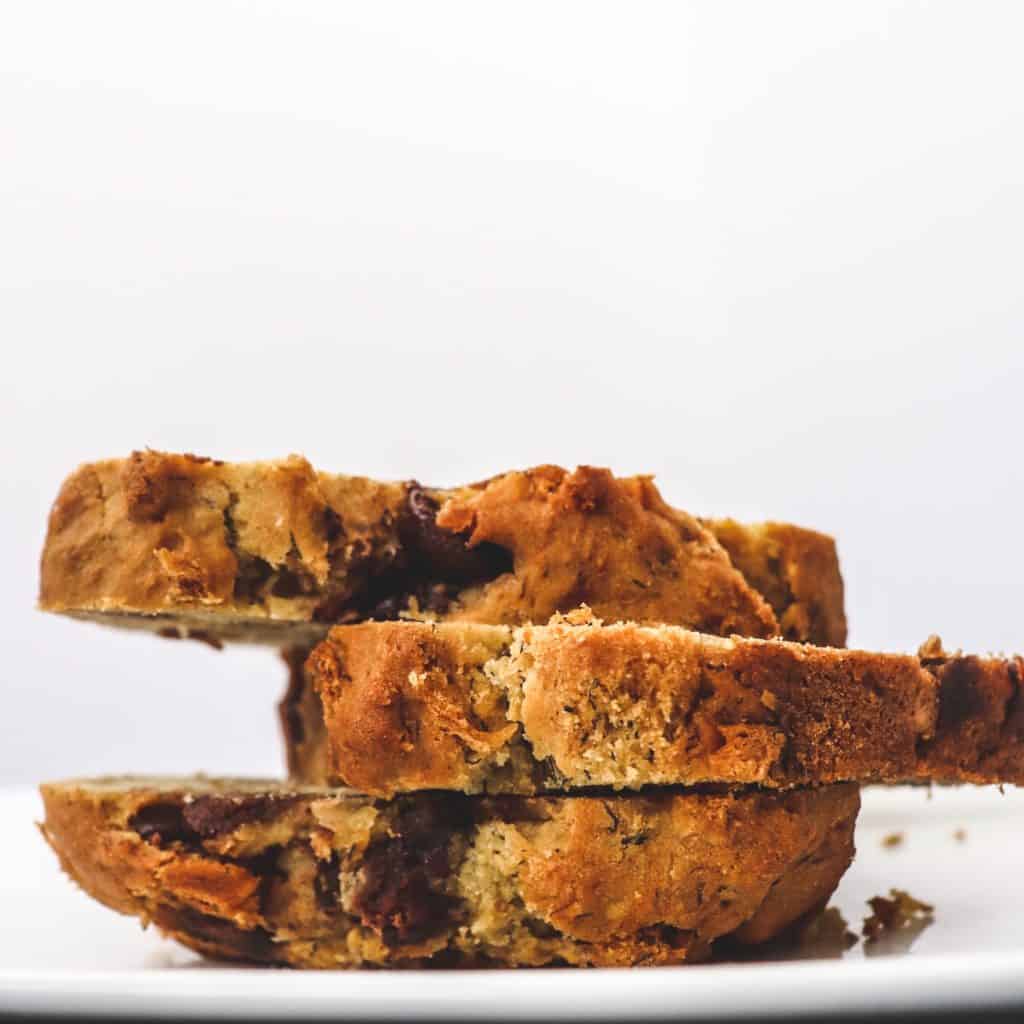 Chocolate chip banana bread slices stacked on a plate