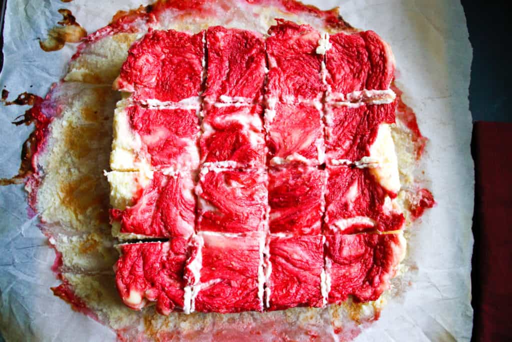 Overhead view of bright red raspberry cheesecake bars