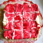 Overhead view of bright red raspberry cheesecake bars