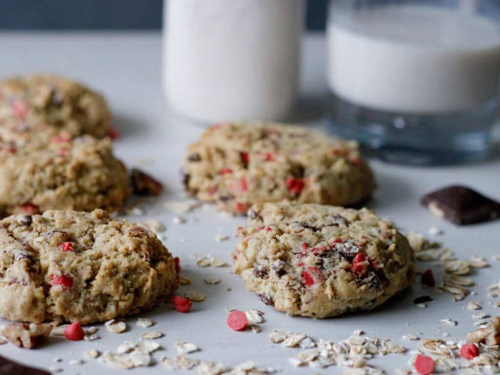Cookies laid out on paper with glass of milk