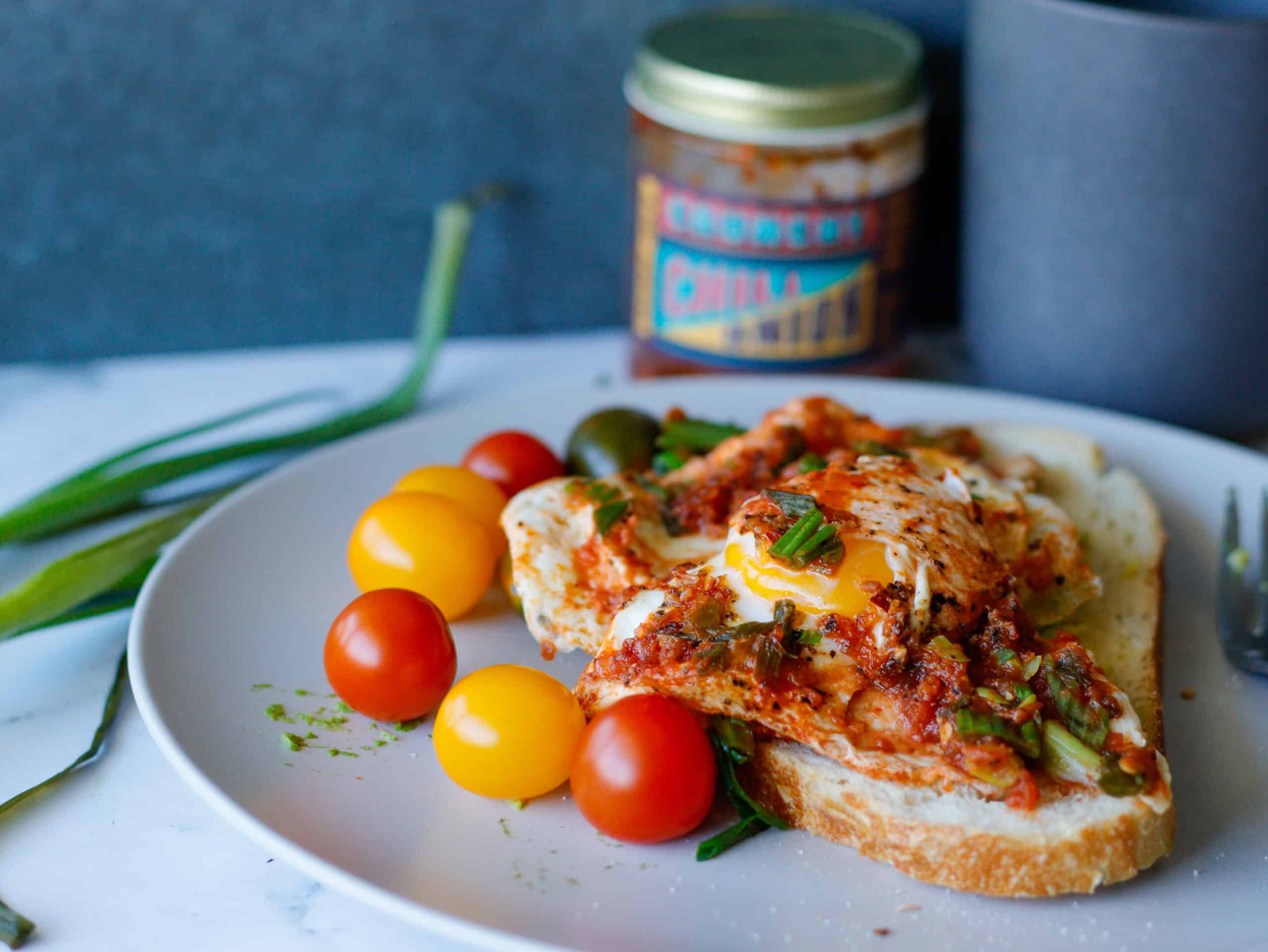 Avocado Toast with Cherry Tomatoes on the side and a mug in the background