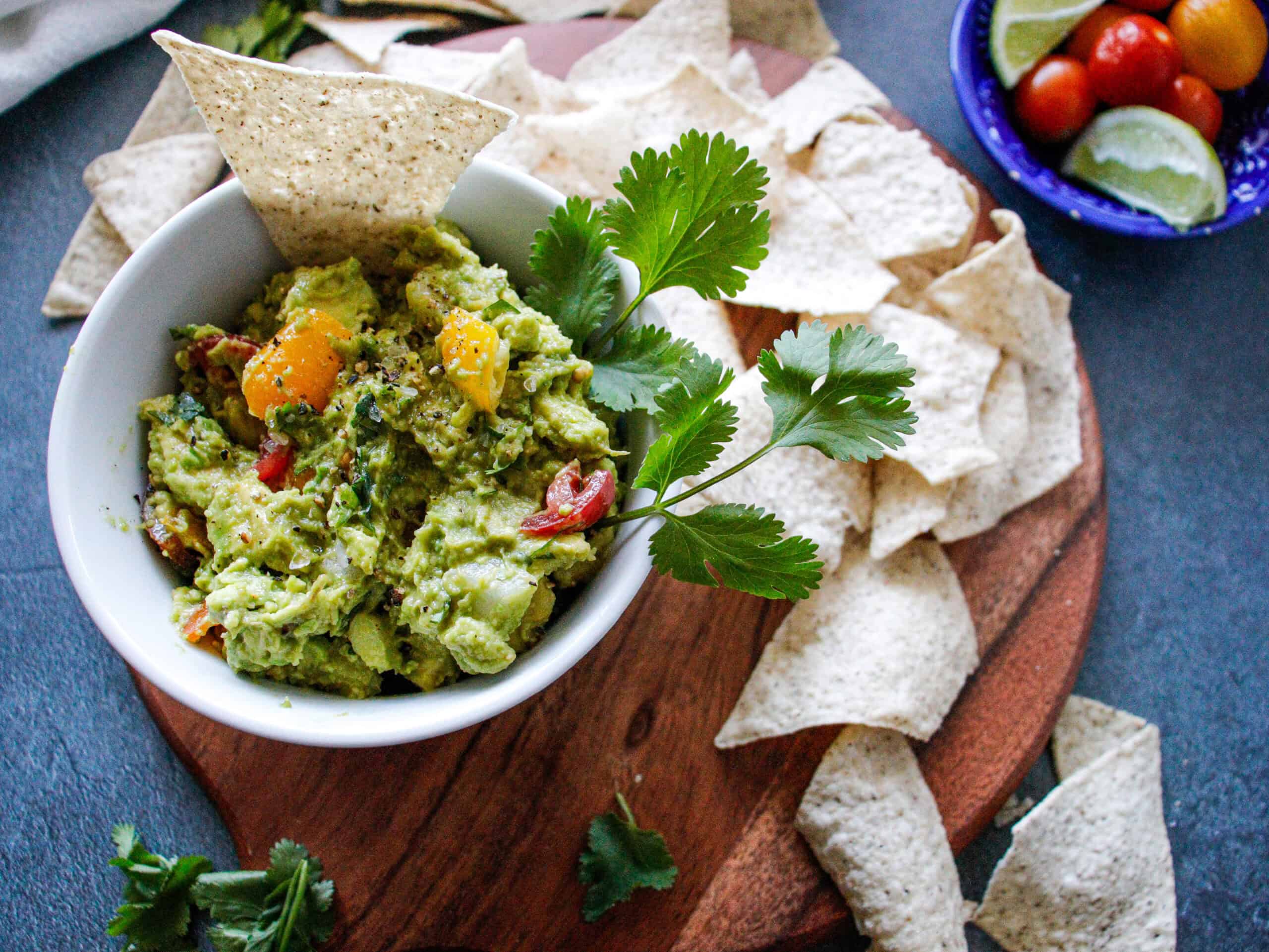 Guacamole in a bowl with chips on the side