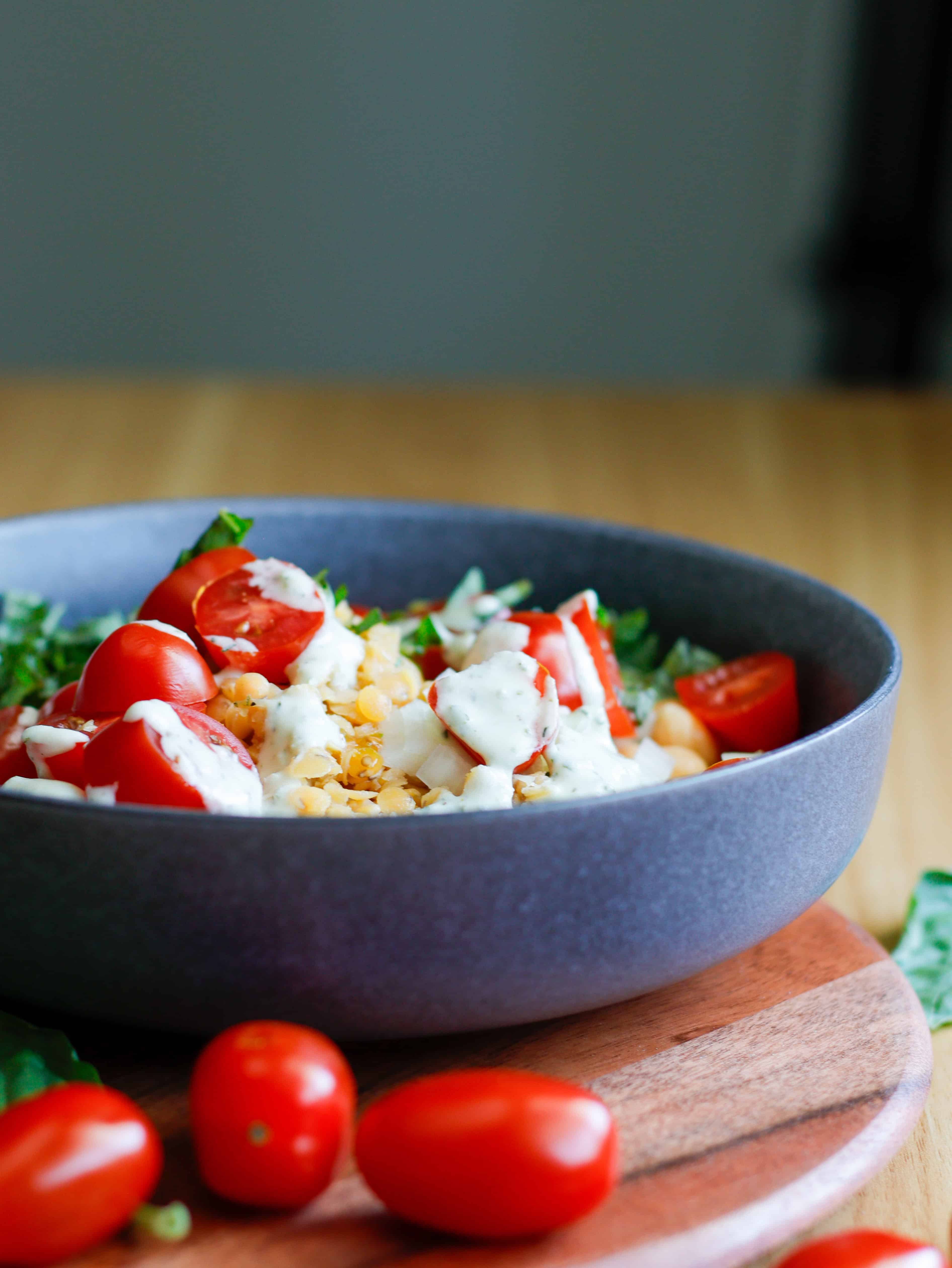 Bowl of lentils, tomato, basil and a creamy dill dressing