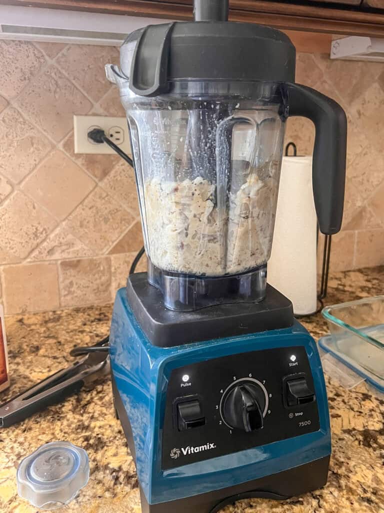 Vitamix blender filled with potatoes for Garlic Tahini Mashed Potatoes.