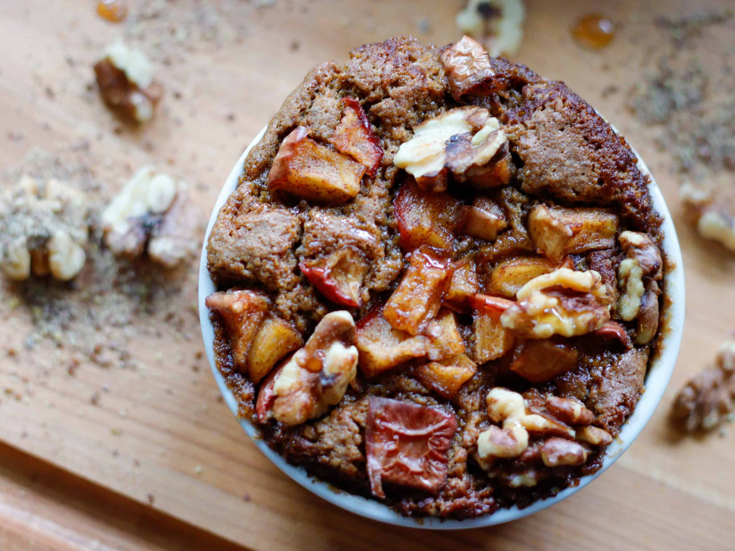Pumpkin Apple Bake in a small white dish on a wood cutting board