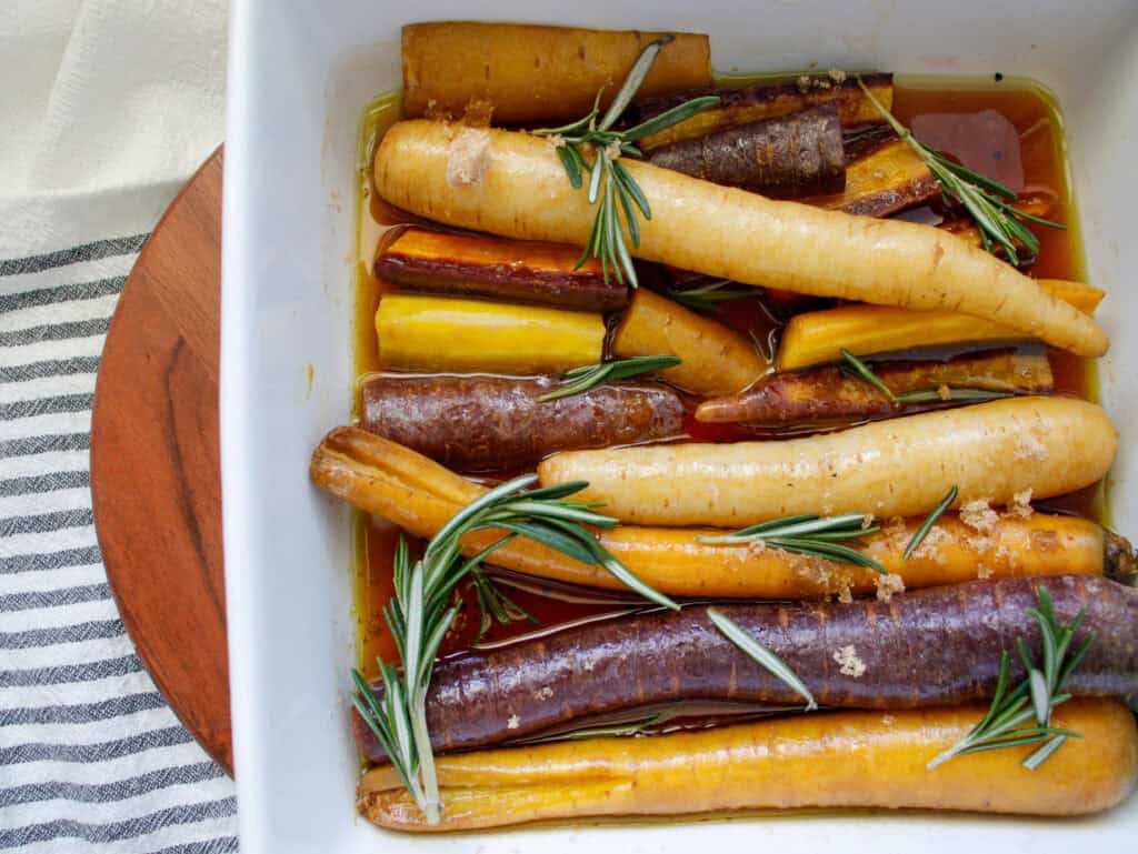 Rainbow carrots layered in a baking dish