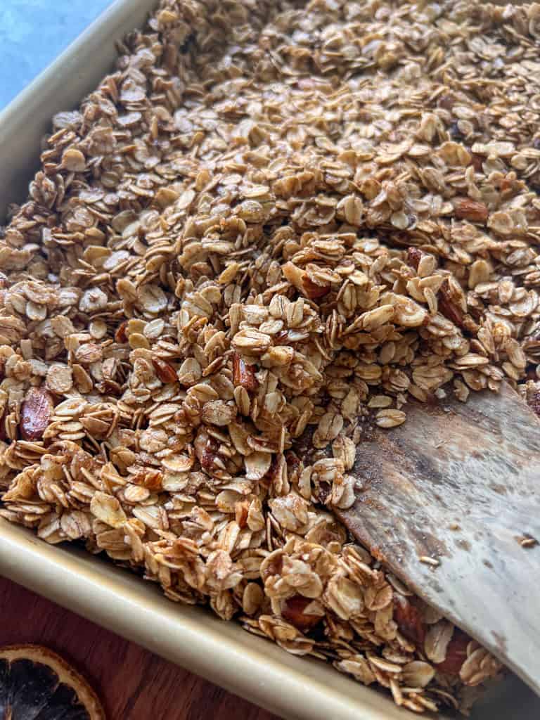 Granola spread on a baking sheet