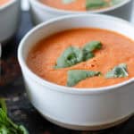 Bowl of tomato soup with basil sprinkled on top