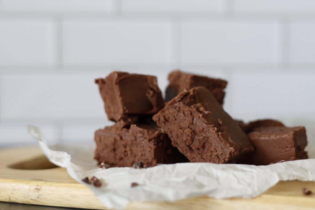 Blocks of gooey chocolate fudge on parchment paper