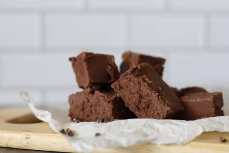 Blocks of gooey chocolate fudge on parchment paper
