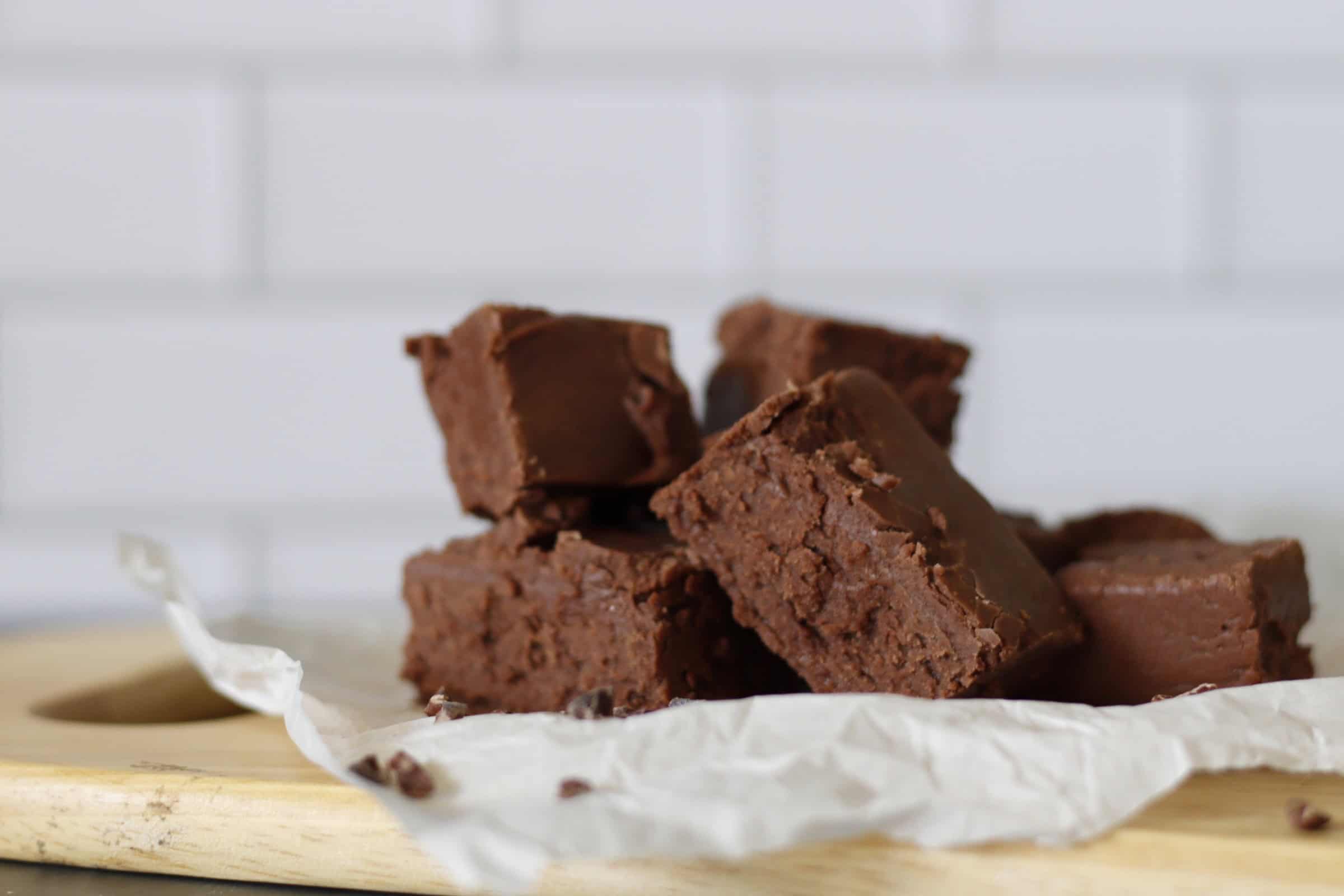Blocks of gooey chocolate fudge on parchment paper