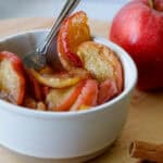Cinnamon Apples in a small white bowl with a fork