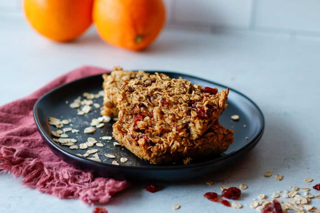 Orange Cranberry Oatmeal Bars on a black plate