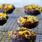 Chocolate donuts on a wire baking rack