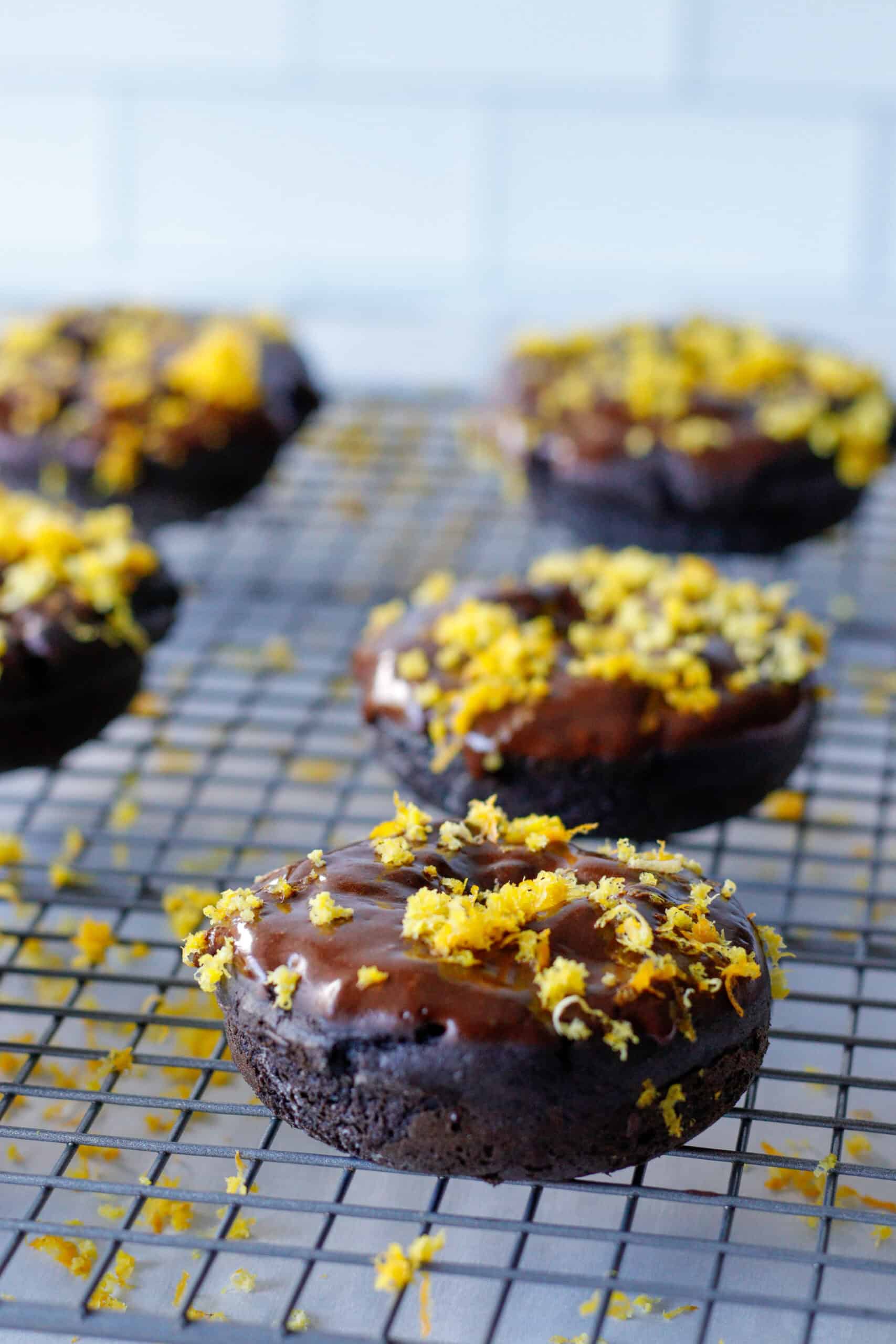 Chocolate donuts on a wire baking rack