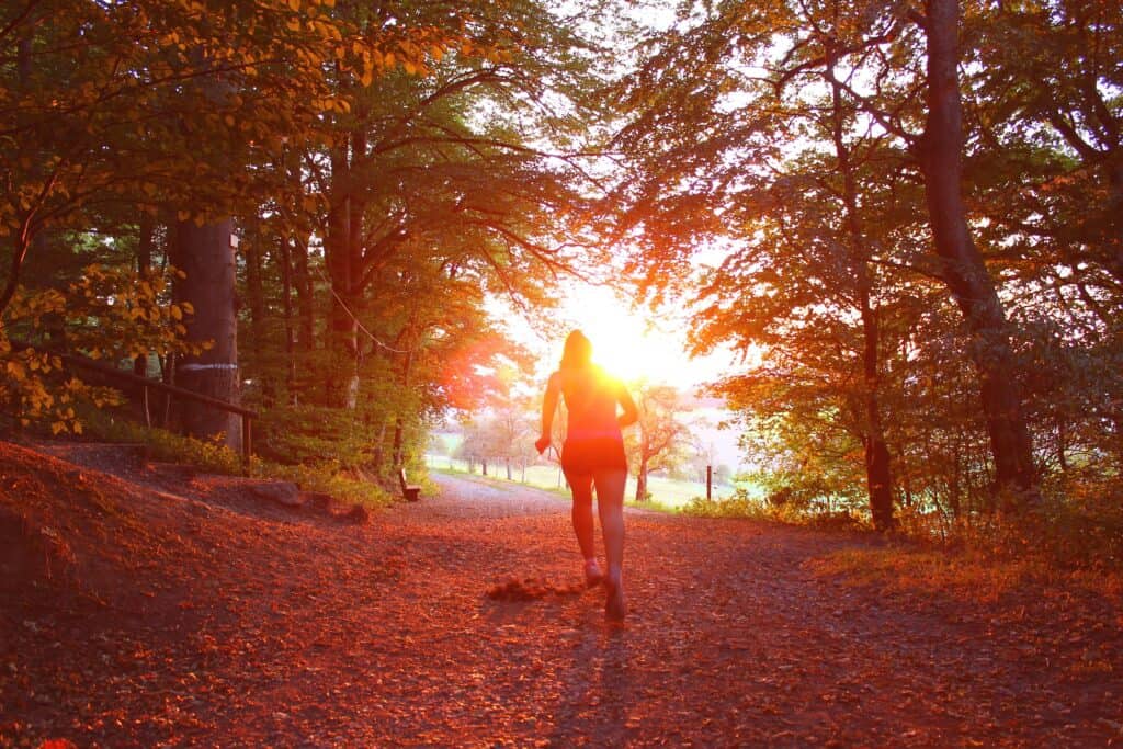 women running into the sunset
