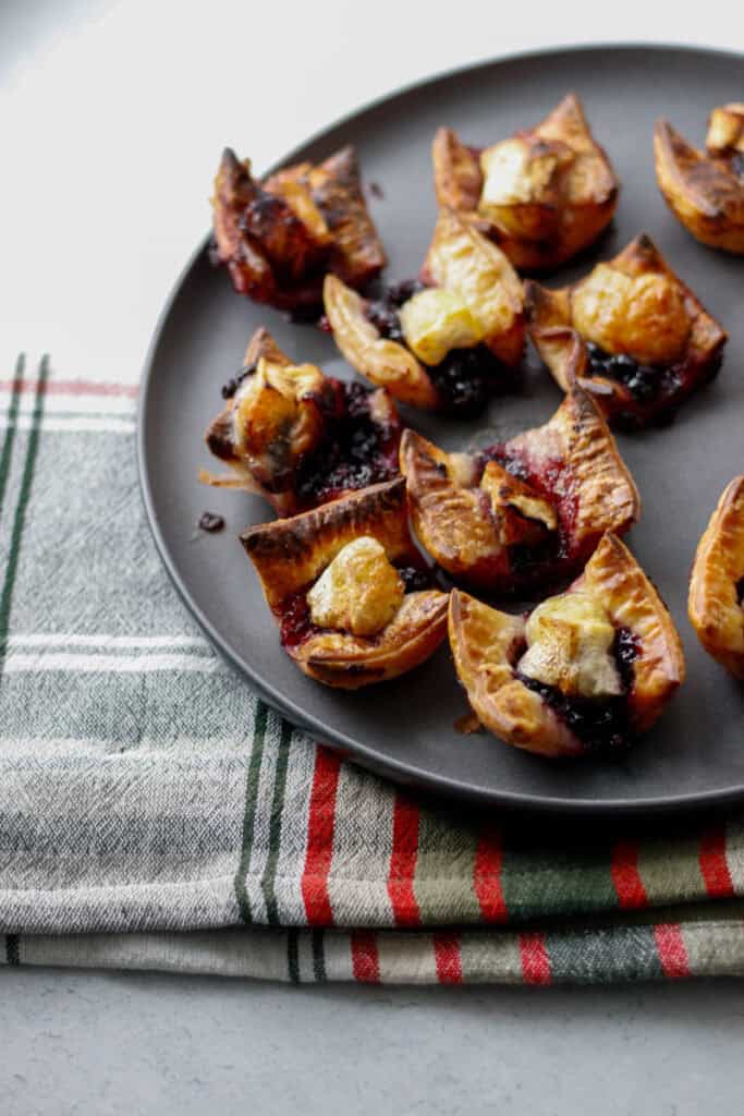 gluten free blueberry brie bite appetizer on a gray plate