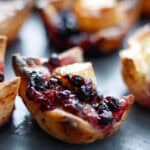 close up of a gluten free brie bite with blueberry jam