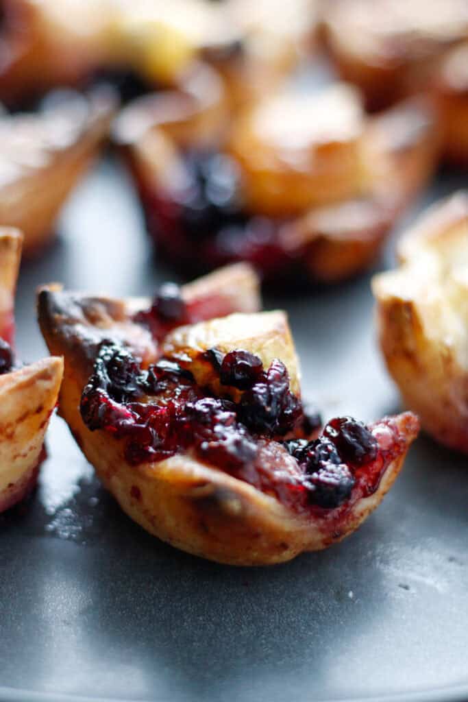 close up of a gluten free brie bite with blueberry jam