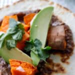 Close up of vegetarian taco topped with avocado