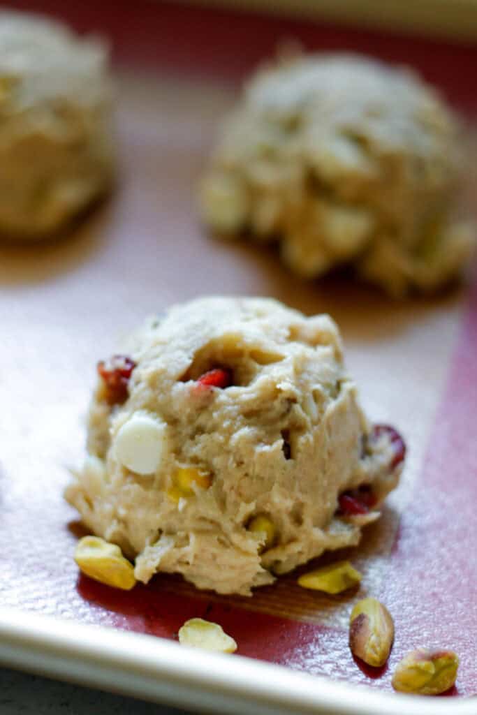 cookie dough ball with cranberries on a baking sheet