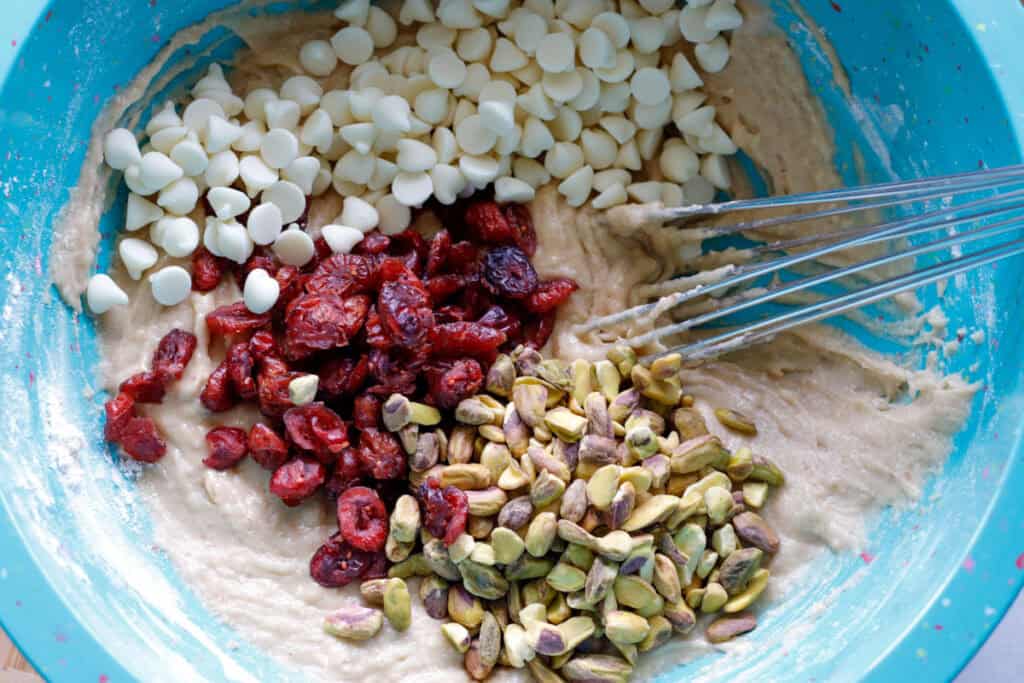 Mixing bowl with cookie mix, pistachios, cranberries and white chocolate chips
