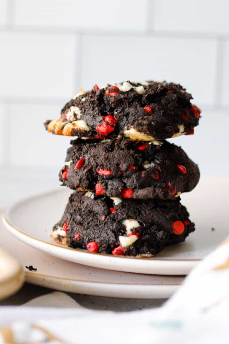 stack of double chocolate cherry chip cookies on a white plate