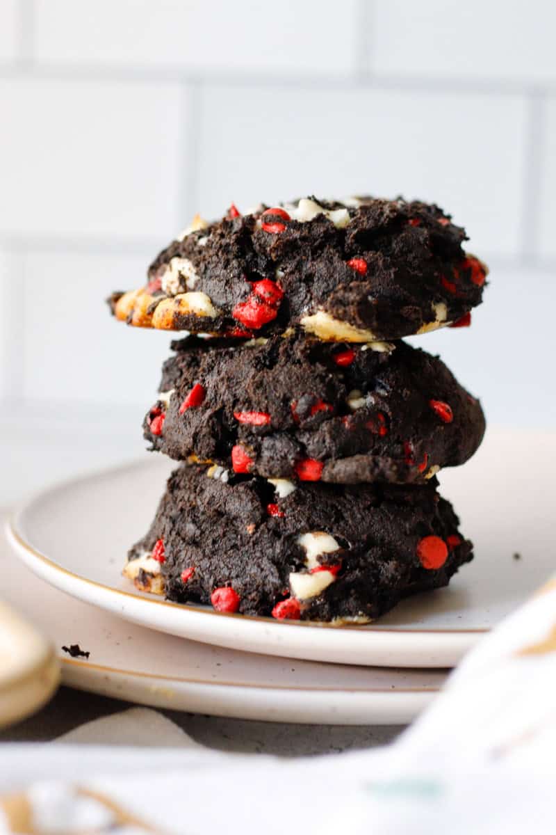 stack of double chocolate cherry chip cookies on a white plate
