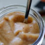 Close up on a brown thick date paste sweetener in a mason jar