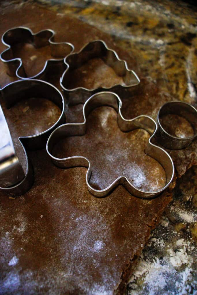 close up gingerbread dough and cookie cutters