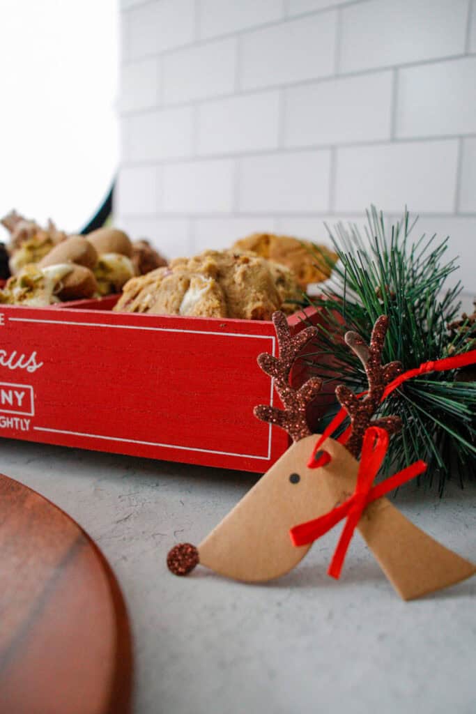 reindeer gift tag next to a holiday cookie box