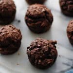 7 small chocolate espresso muffins on a white serving plate