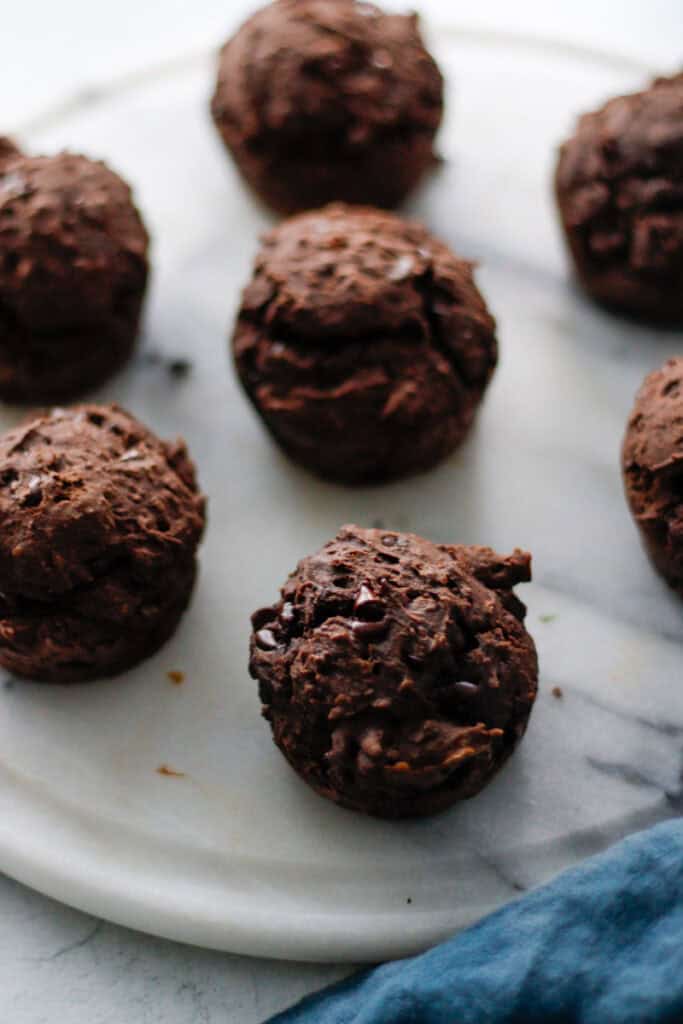 7 small chocolate espresso muffins on a white serving plate