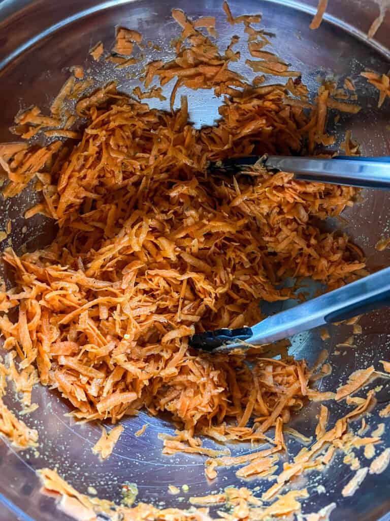 Mixing bowl with sweet potato shreds and spices for a tasty crispy hot honey treat