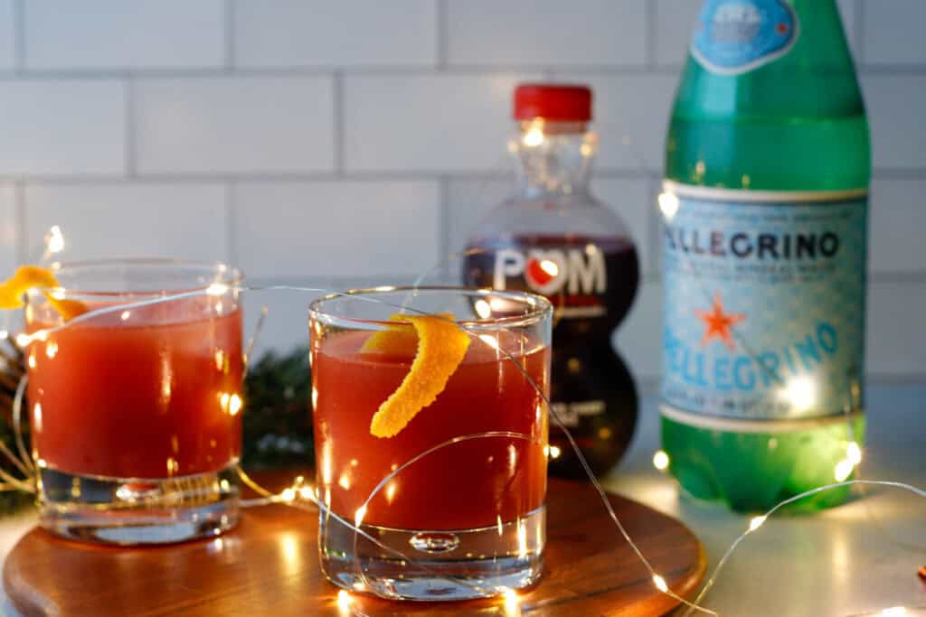 Sparkling mocktail on a tray with holiday lights