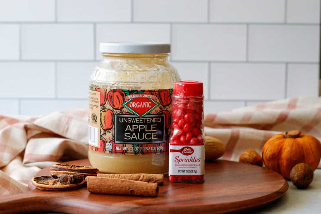 Unsweetened applesauce and a bottle on cinnamon imperial red hot sprinkles