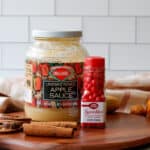 Unsweetened applesauce and a bottle on cinnamon imperial red hot sprinkles