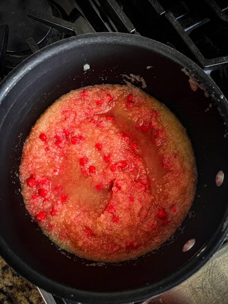 Sauce pan with applesauce and cinnamon red hot candies