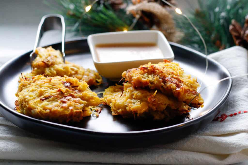 Oven baked spaghetti squash on a black serving dish with maple aoli recipe