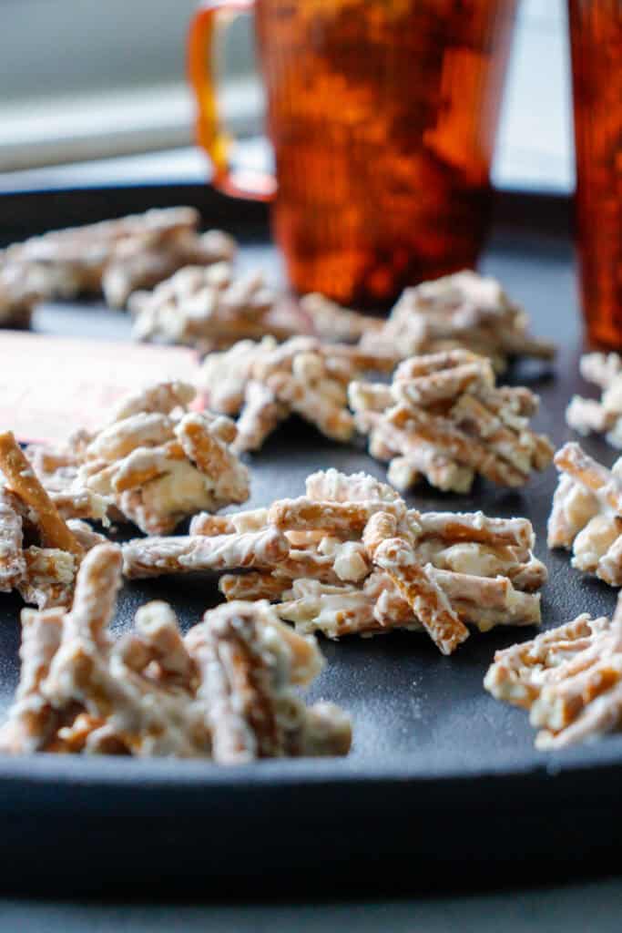 white chocolate pretzel peanut stacks on a black tray