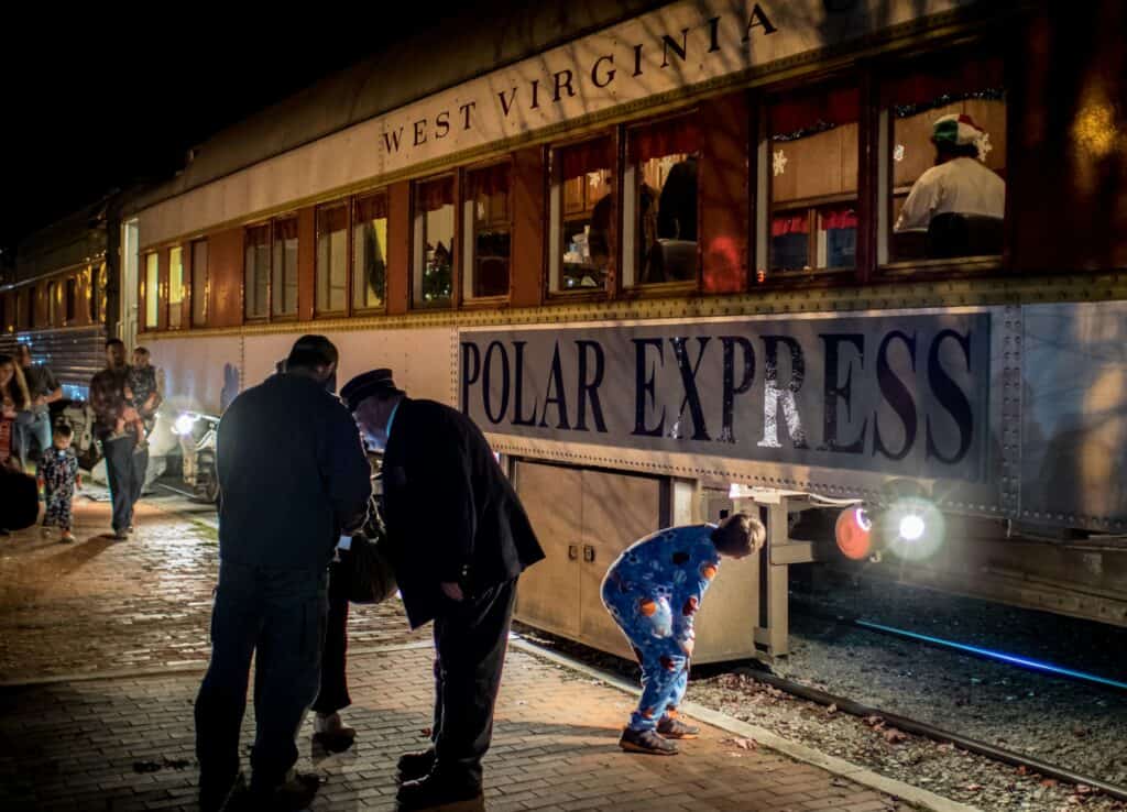 polar express inspired image with train and families at christmas