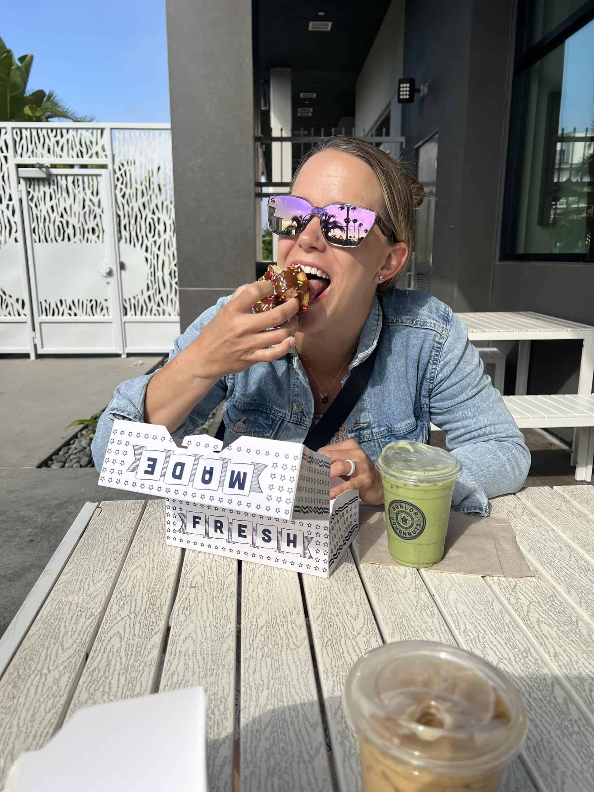 McKenzie creator of Time Stamped Food eating a donut in the california sun