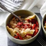 Plated Mediterranean White Bean Skillet served with crusty gluten-free bread. A simple Mediterranean lunch idea loaded with flavor and nutrients.