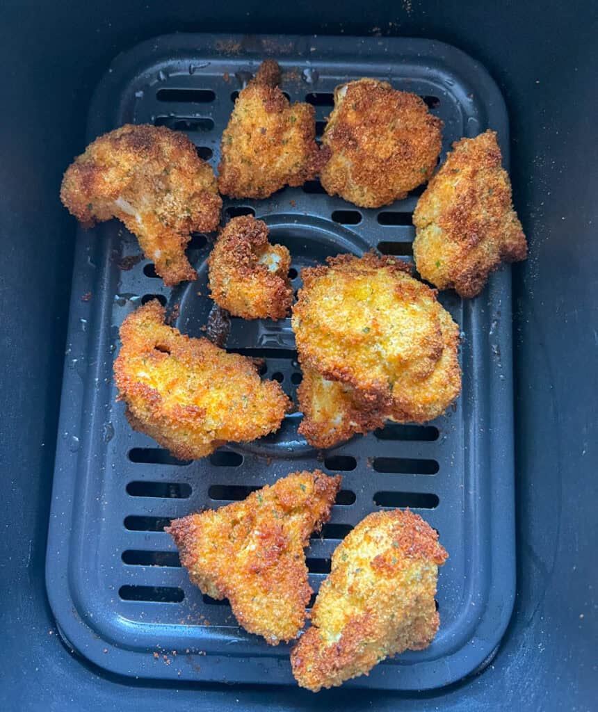 Crispy fried cauliflower bites in air fryer with golden brown coating best healthy snack alternative.