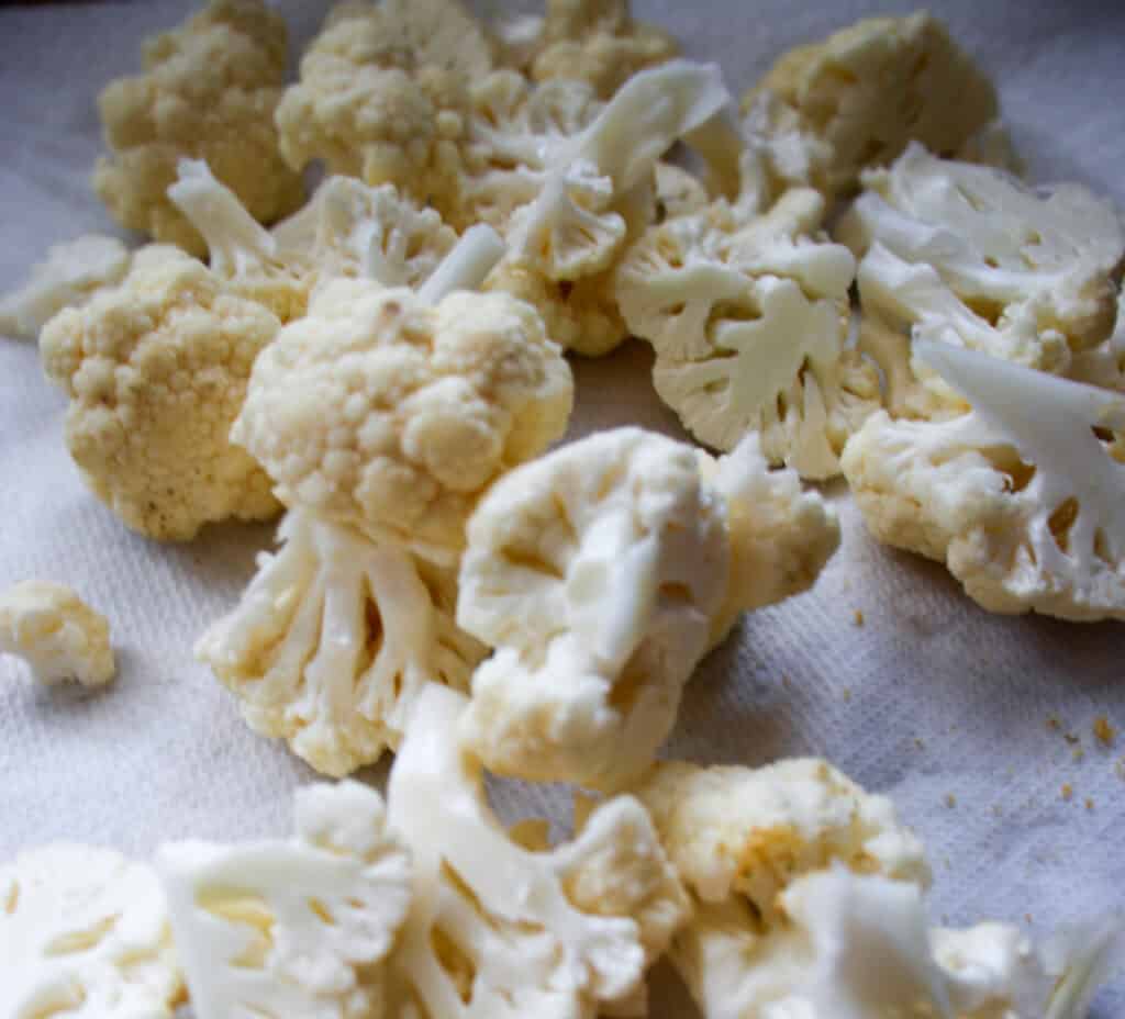 cauliflower florets spread on counter top
